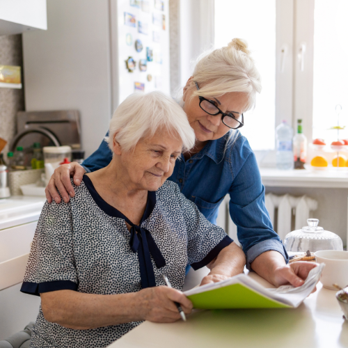 woman looking over plans with her mom. Pre-planning ensures your wishes are known and your loved ones have peace.
