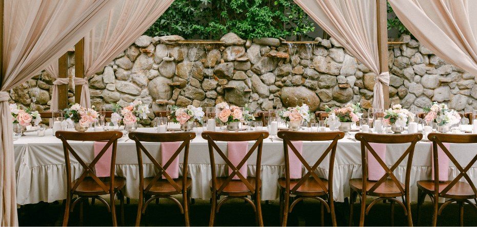 A long draped table set for dinner