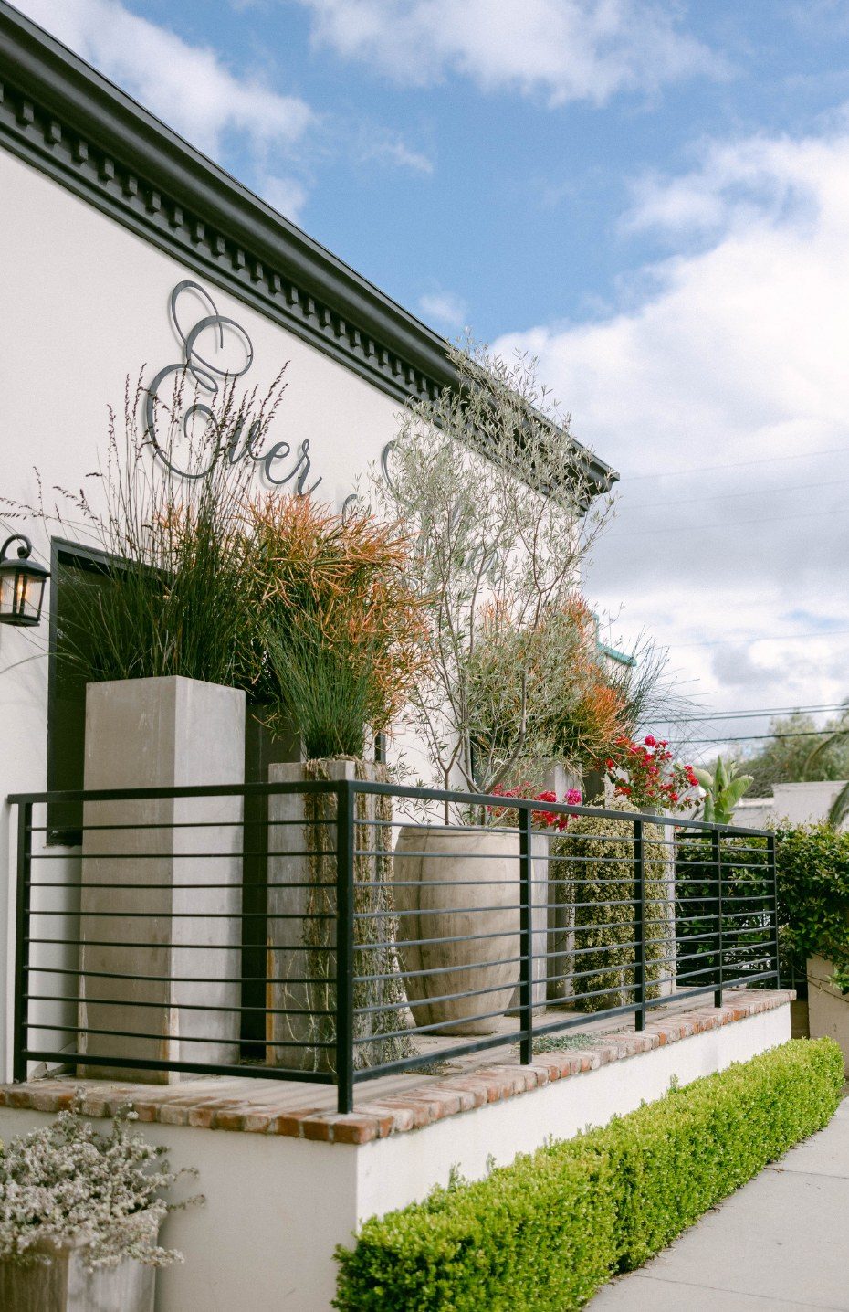 The Ever After Petite entrance with its signature lettering and planters