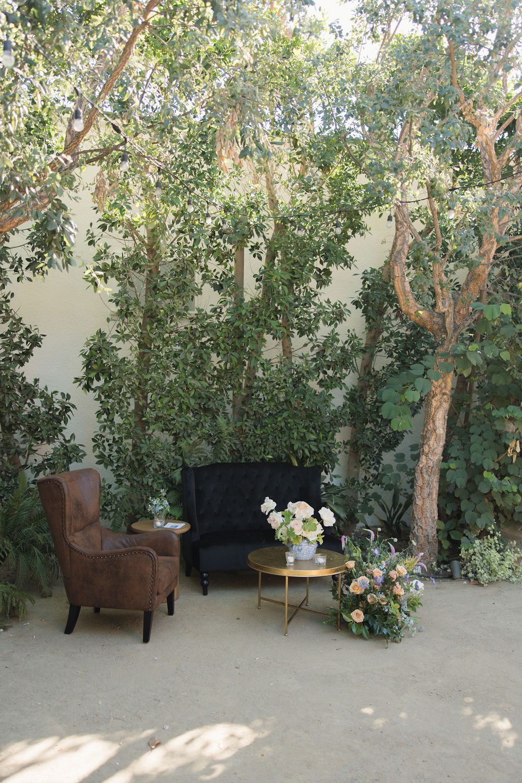 A lounge corner beneath the trees and bistro lights