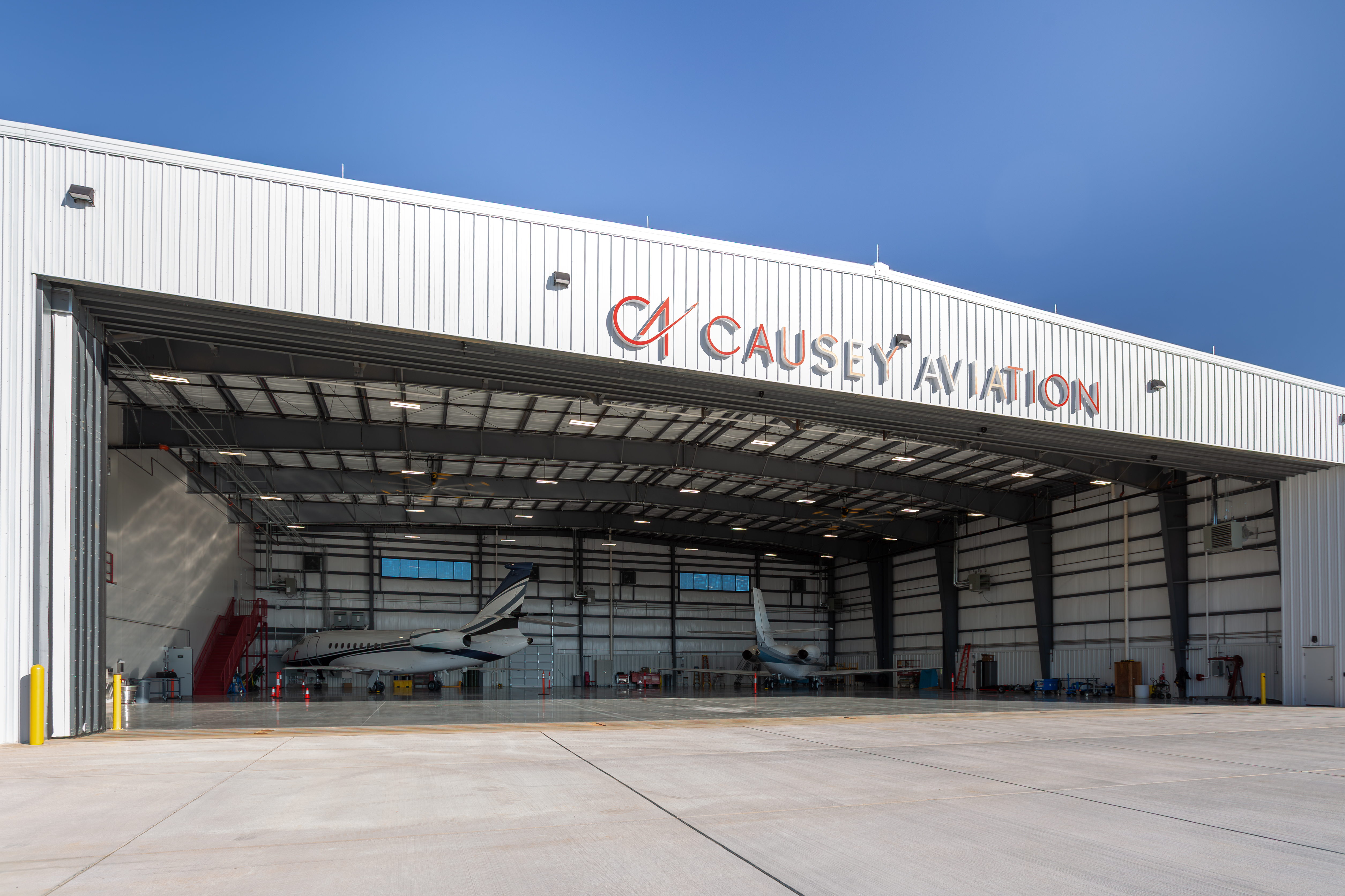 Causey Aviation hangar with open doors and aircraft inside at the company's North Carolina airfield