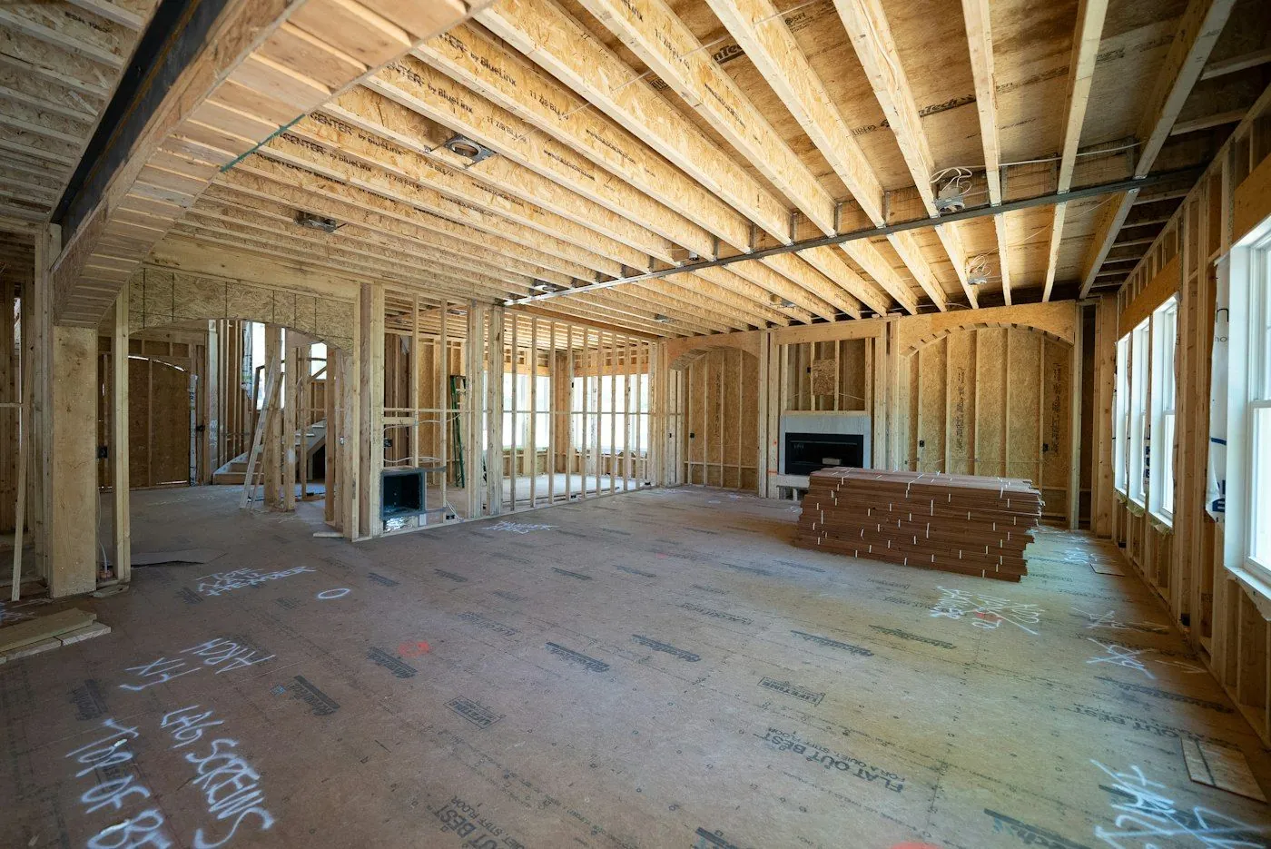 An addition under construction with new wood framing and joists