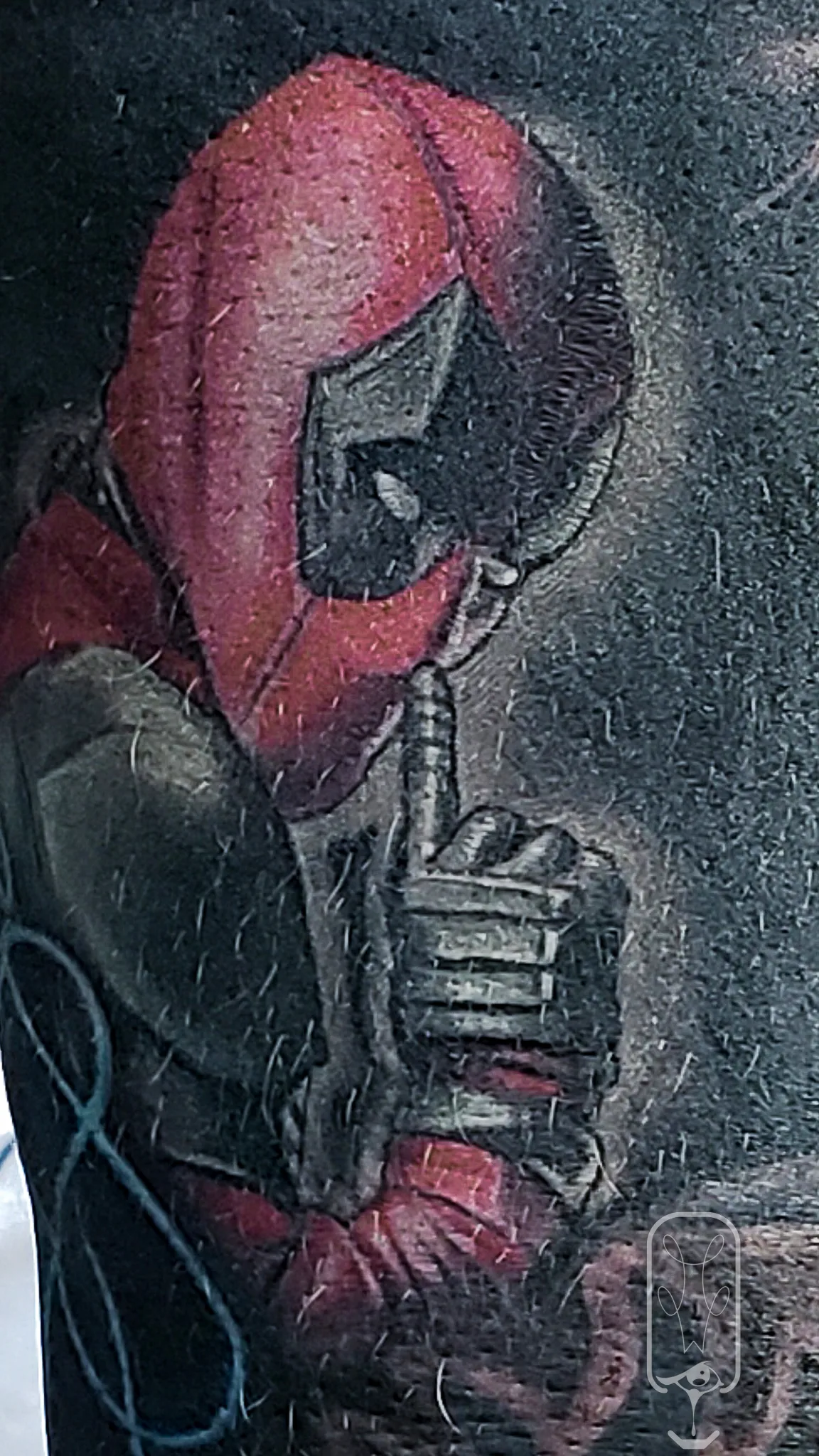 Color Realism Portrait tattoo Missoula, Montana by Mickey at Unorthodox Tattoo, depicting Deadpool in vivid reds and detailed mask shading with painterly realism on skin.