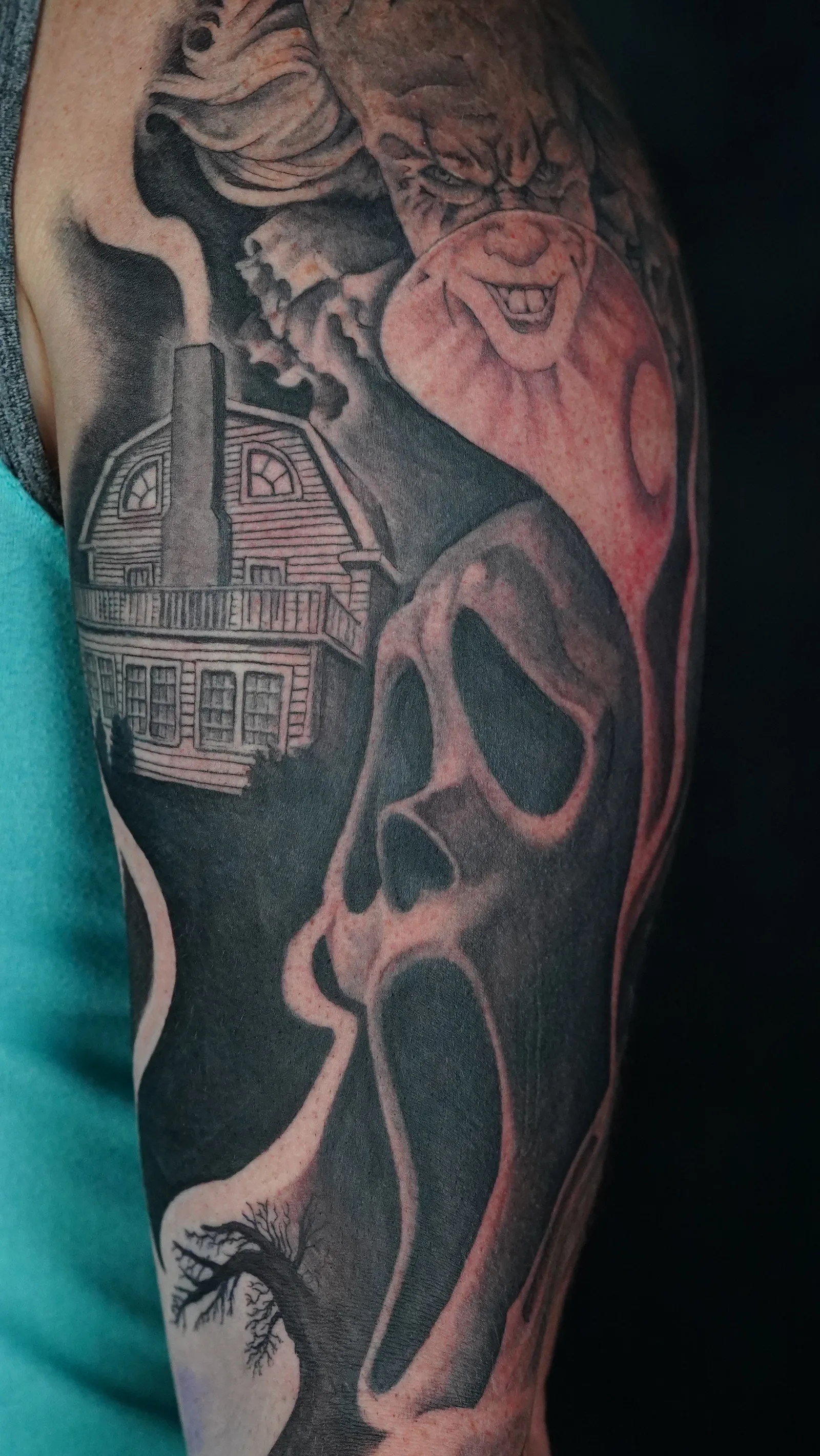 Black and Grey Realism Portrait tattoo Missoula, Montana by Mickey at Unorthodox Tattoo, showing a dramatically shadowed, high-contrast portrait with deep tonal range and fine detail in the skin highlights.