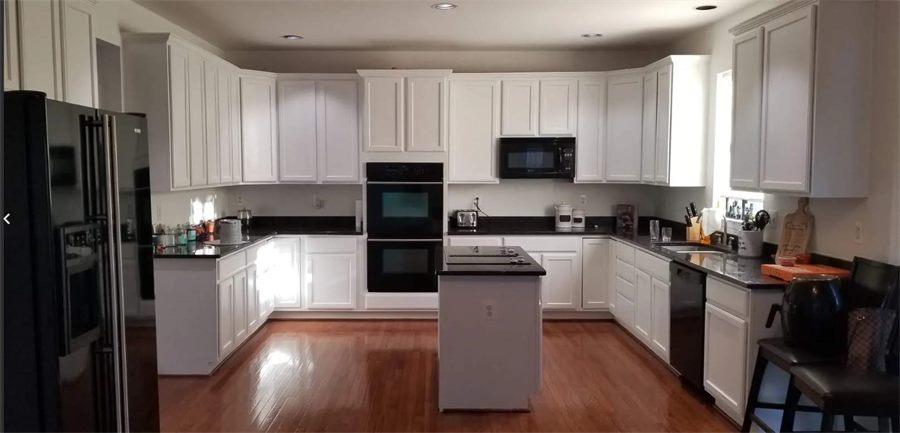 Same kitchen with cabinets painted white