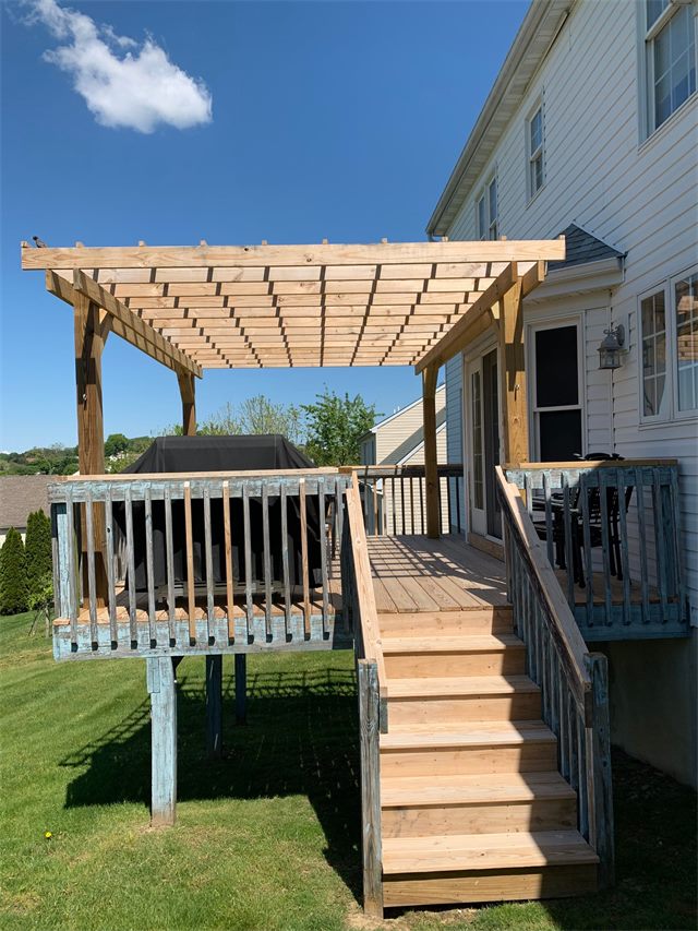 Weathered deck with bare wood stairs before