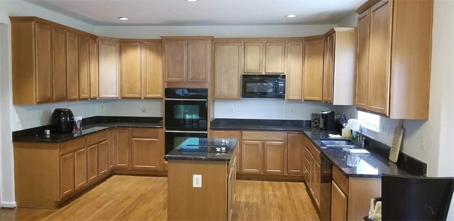 Kitchen with oak cabinets before painting