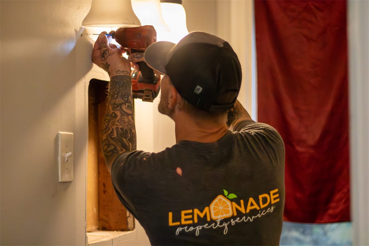 Lemonade technician repairing a light fixture
