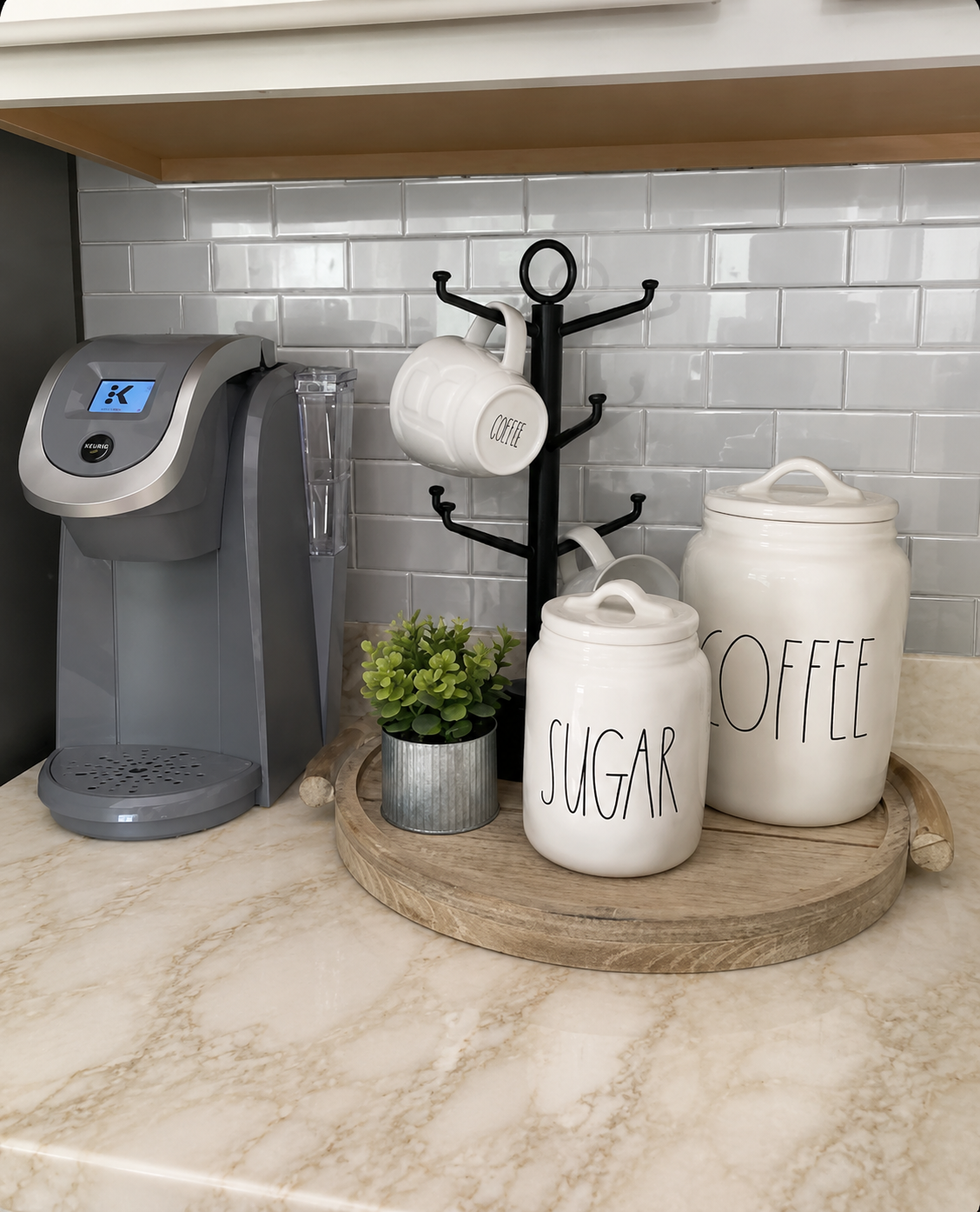 Short-term rental coffee station with Keurig coffee maker, mugs, coffee and sugar canisters, and countertop decor. Short-term rental coffee station with Keurig coffee maker, mugs, coffee and sugar canisters, and countertop decor.