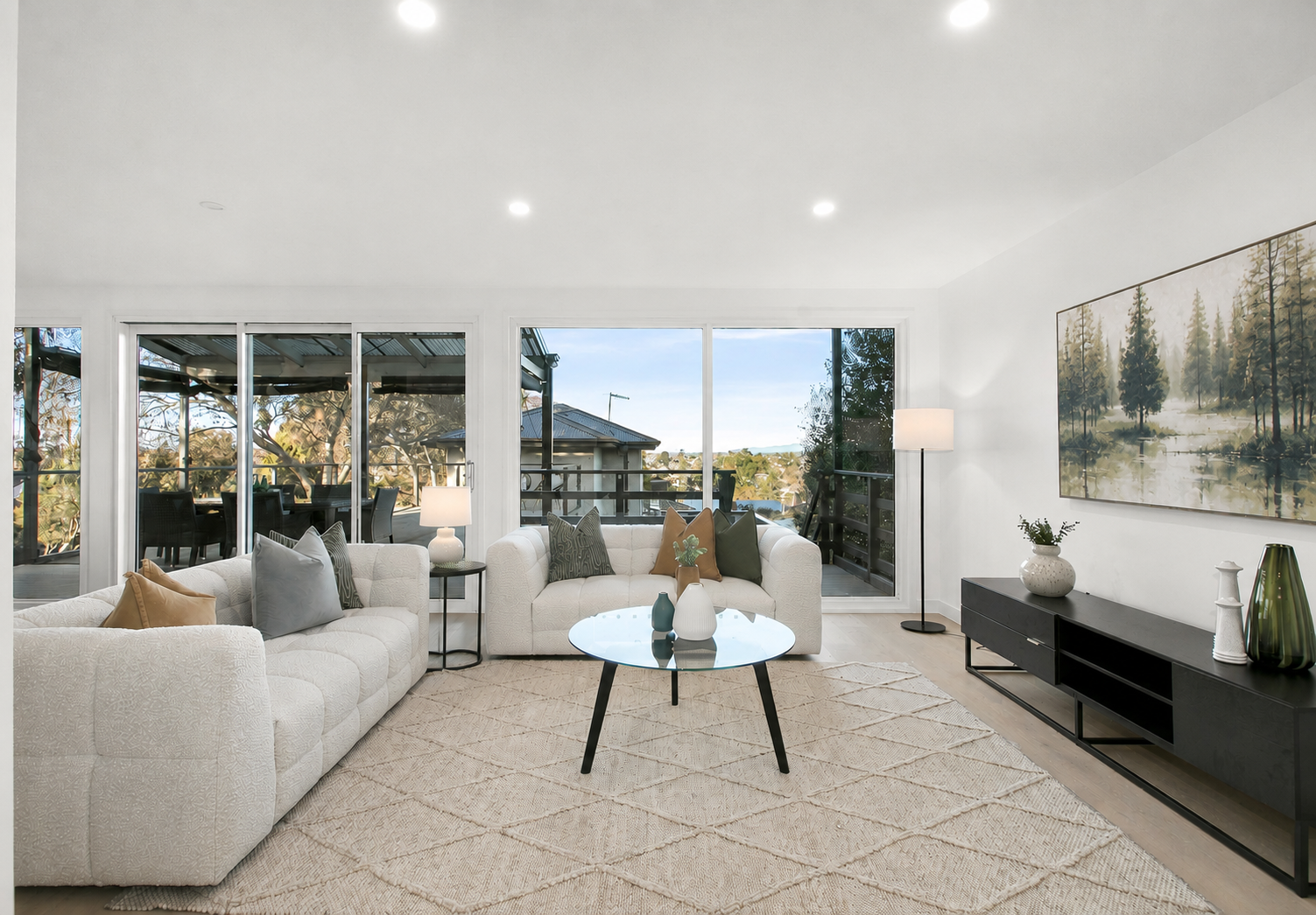 A professional high-end luxury living room in Orlando expertly staged for sale with natural light and modern neutral furniture.