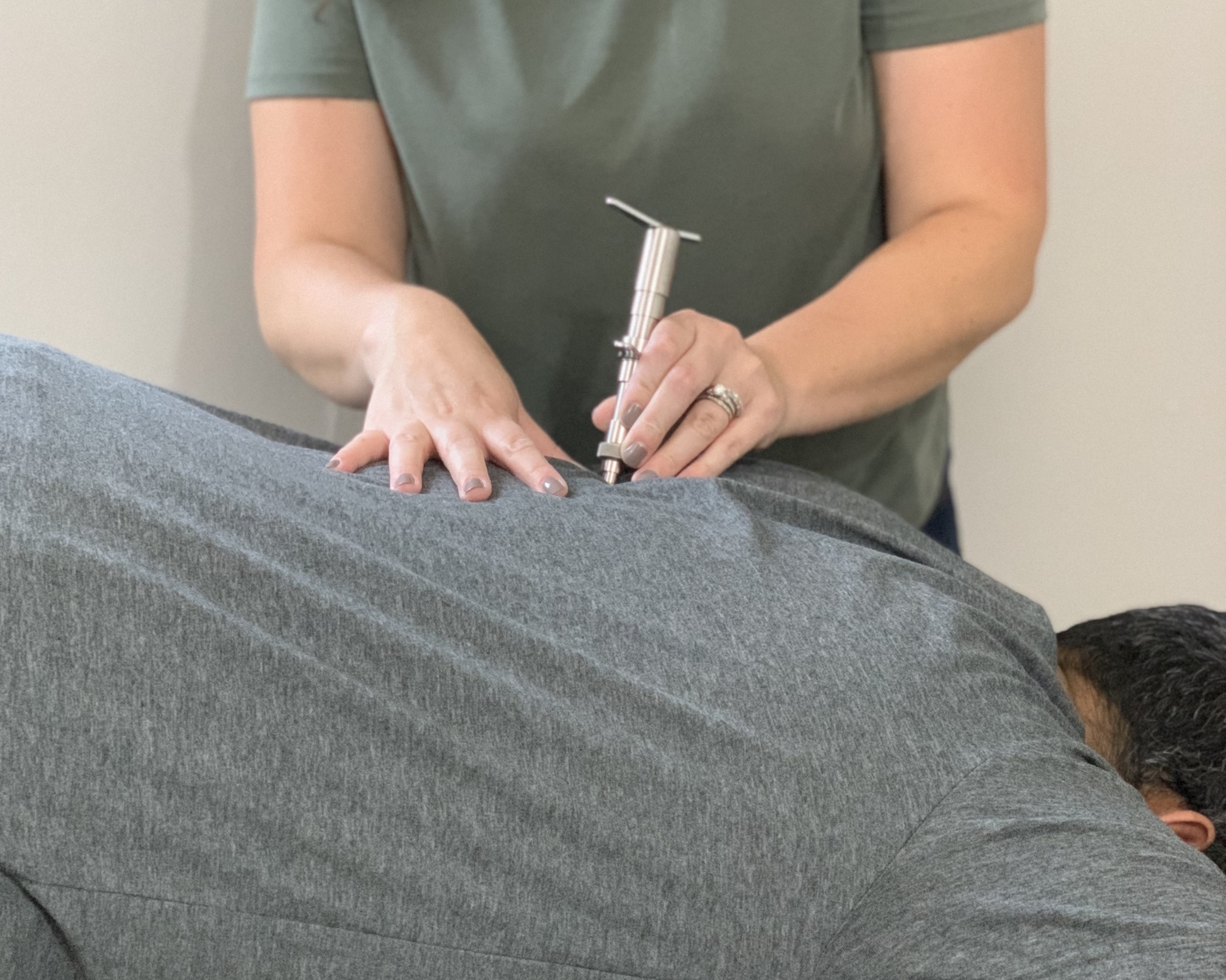 Chiropractor using the Integrator instrument for a Torque Release Technique adjustment