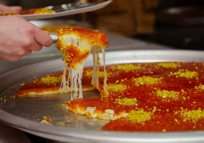 Freshly made Palestinian knafeh nabulseyeh glistening with syrup and pistachios