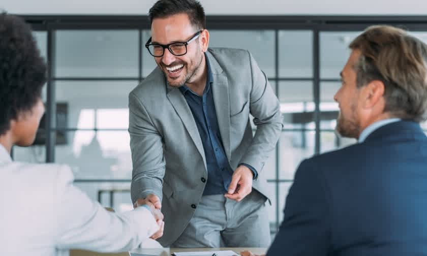 Insurance agent closing a deal with a handshake