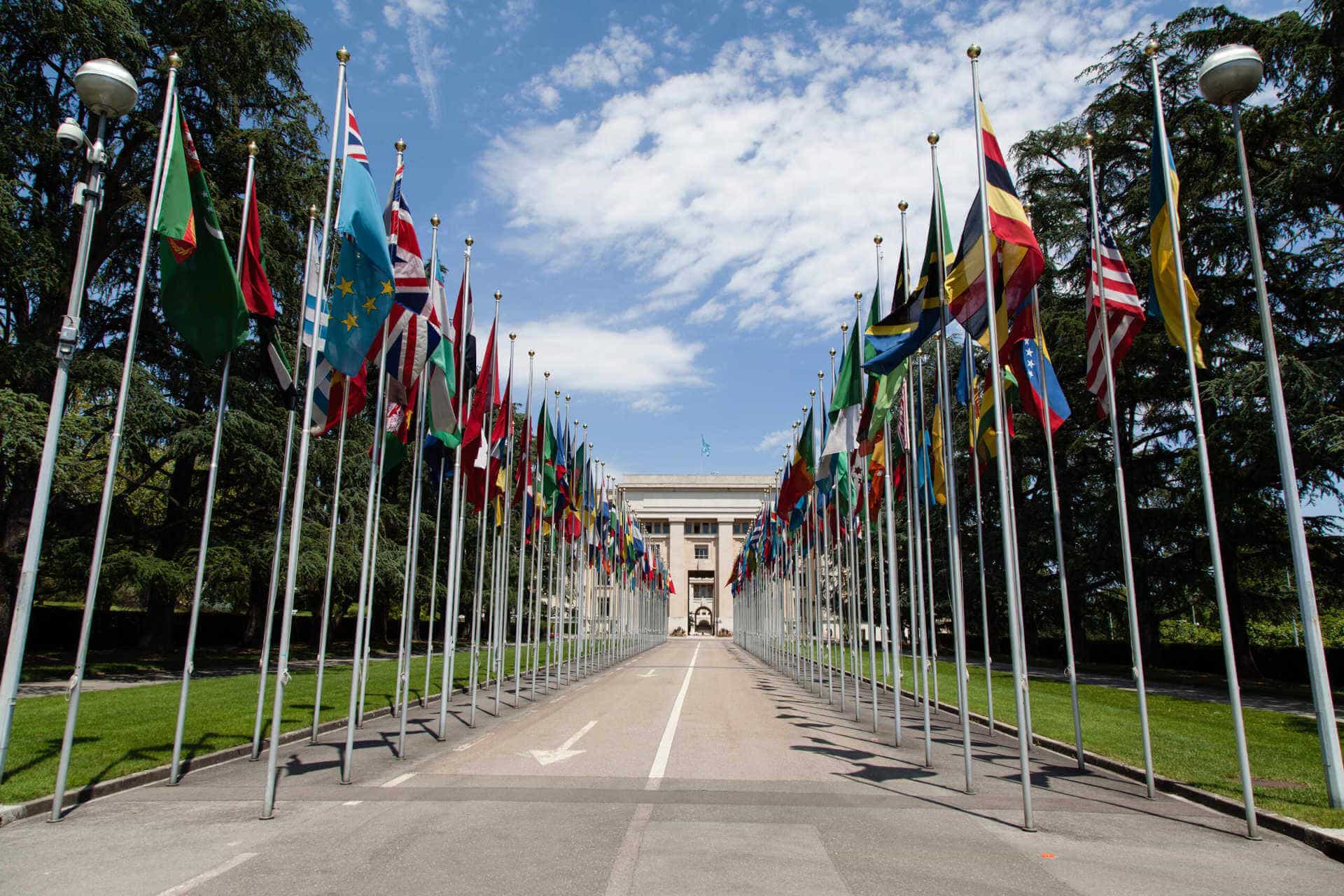 front of United Nations building with all the flags of the world