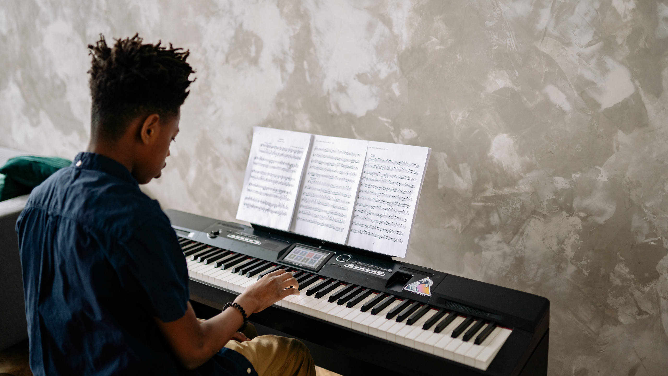 A young man practicing a Piano 