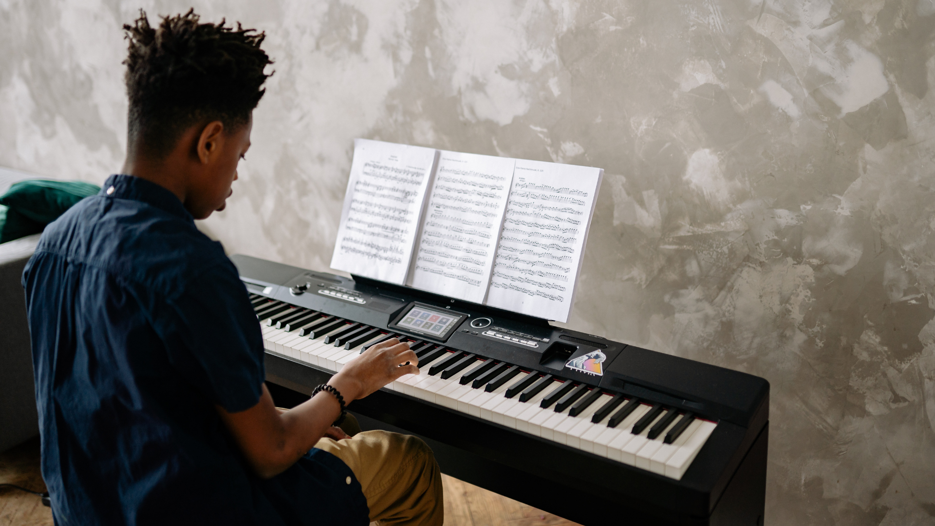  boy focus on practicing piano