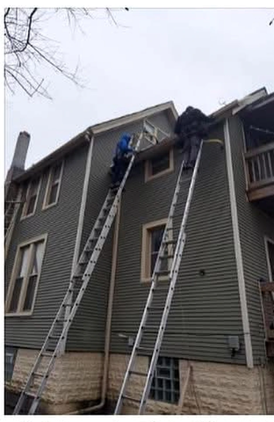 Field-service professionals completing exterior work at a residential property.