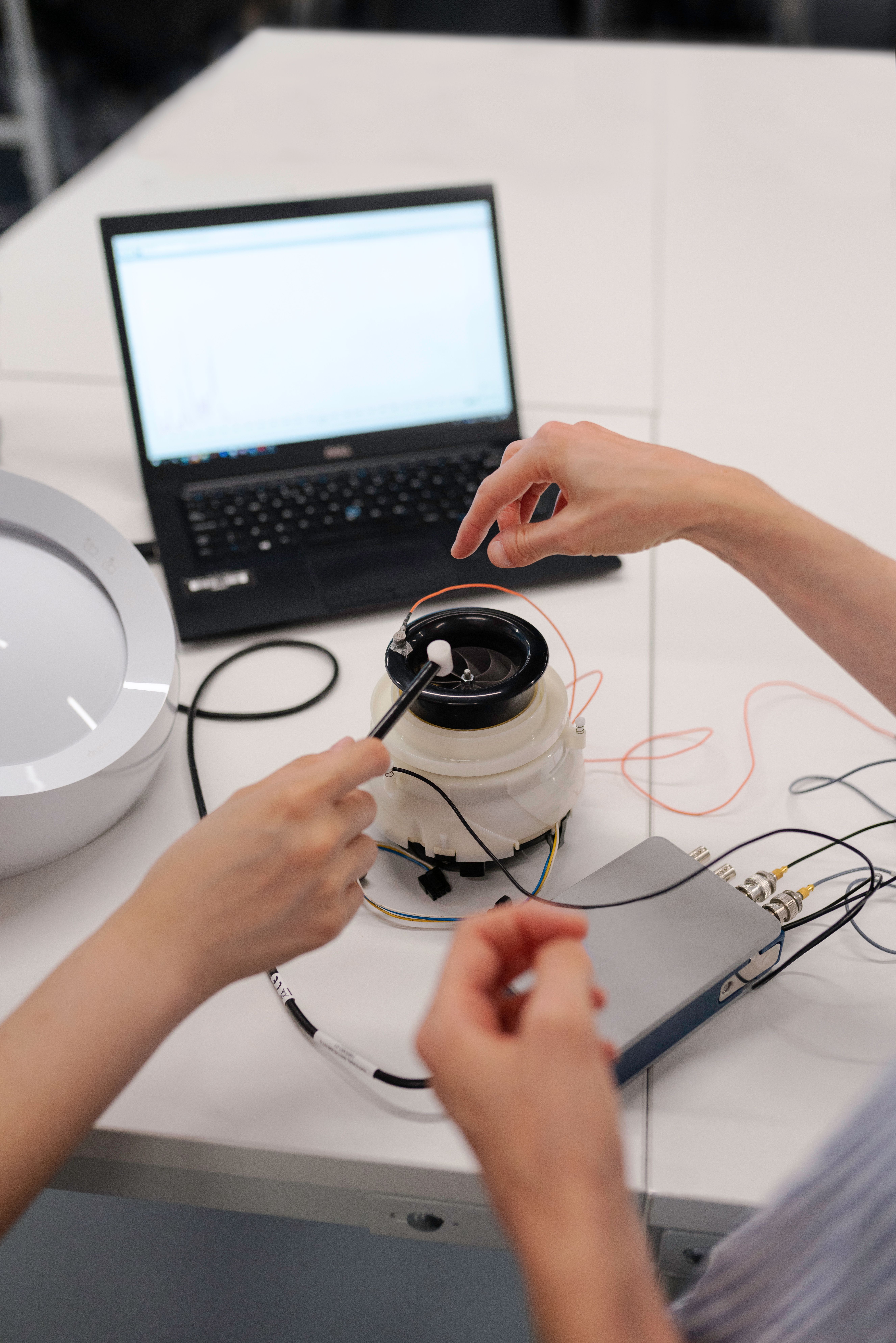 Engineers testing and refining a product implementation.
