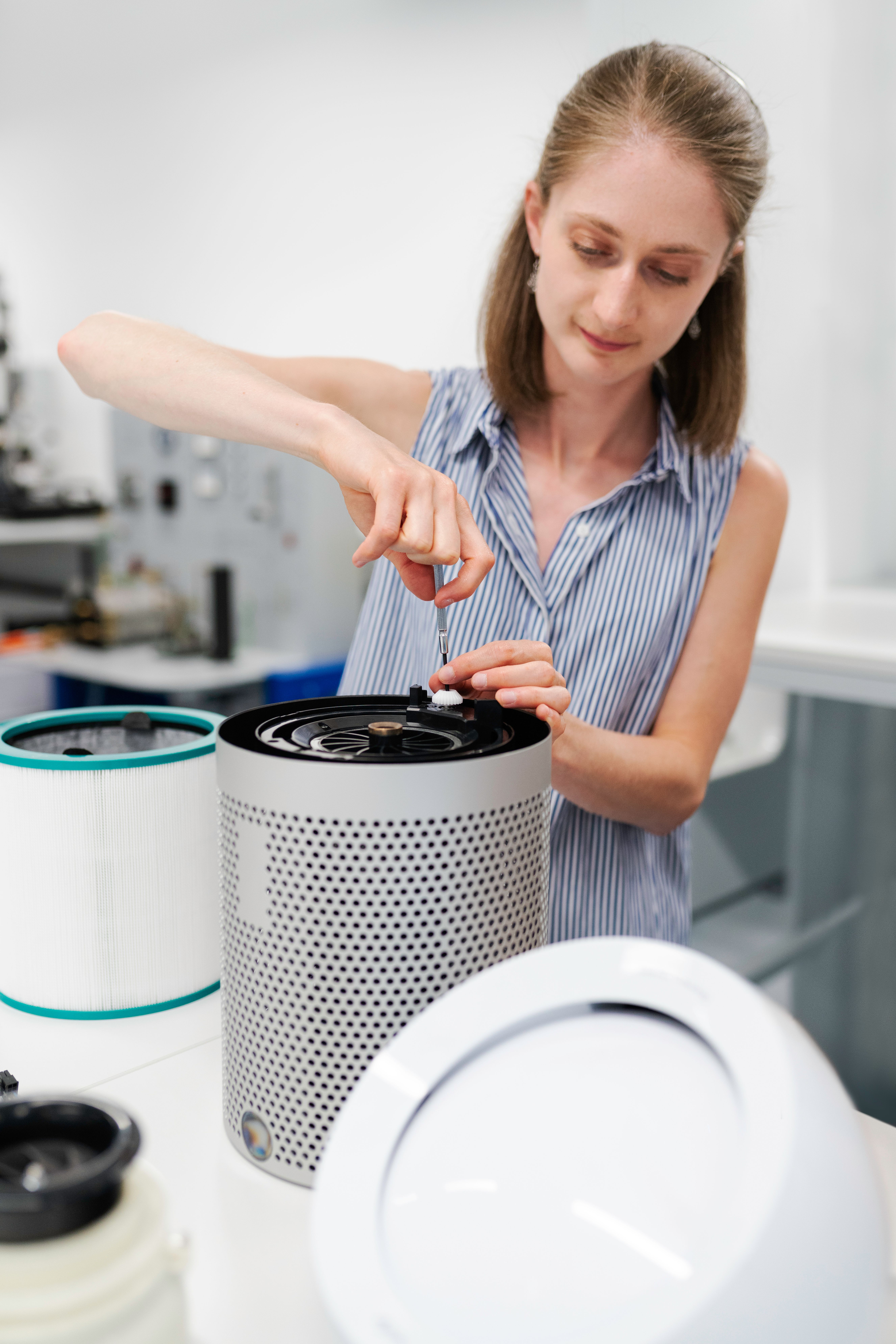 Engineer reviewing technical work in a bright laboratory.