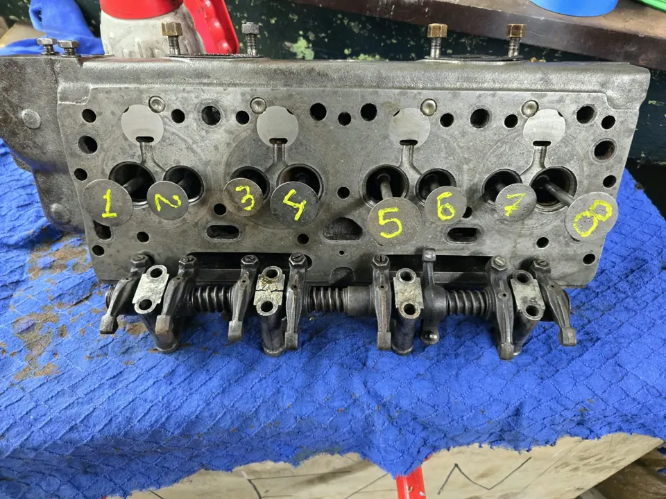 Cylinder head with valves numbered 1 to 8 during a classic engine rebuild