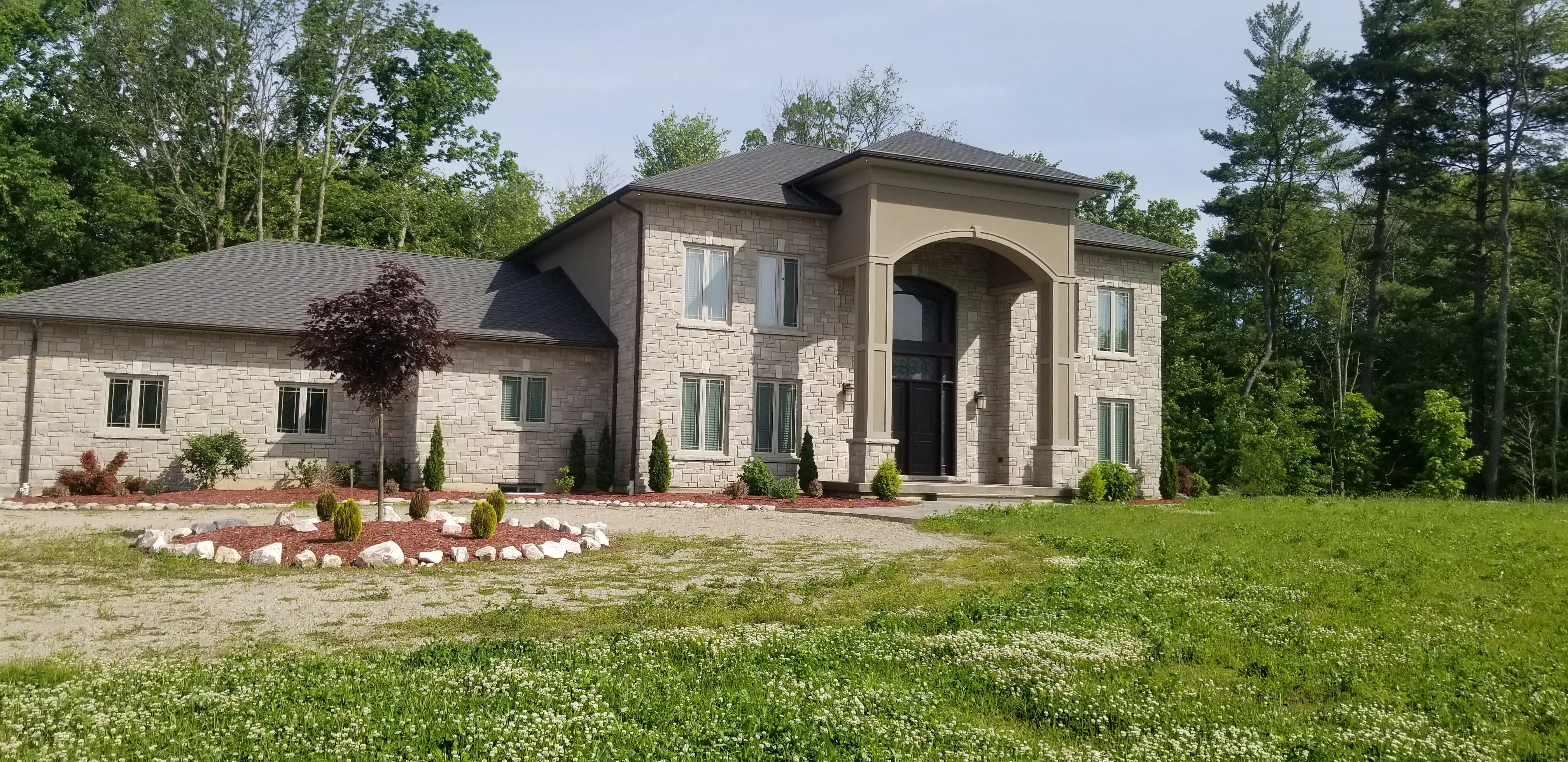 Custom home stucco arched entrance — Norfolk County