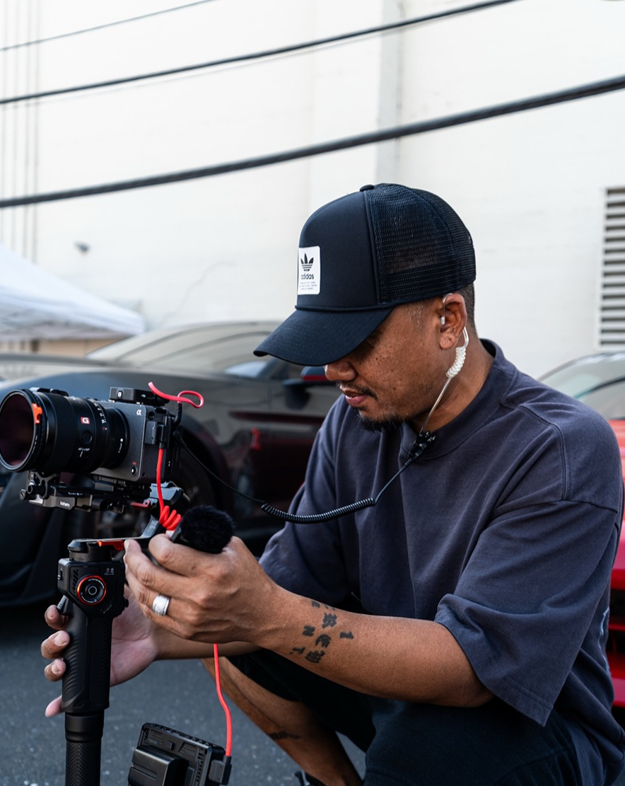 Gane, CnC Sac&rsquo;s Vice President, operating a cinema camera rig at a Cars and Coffee Sac event