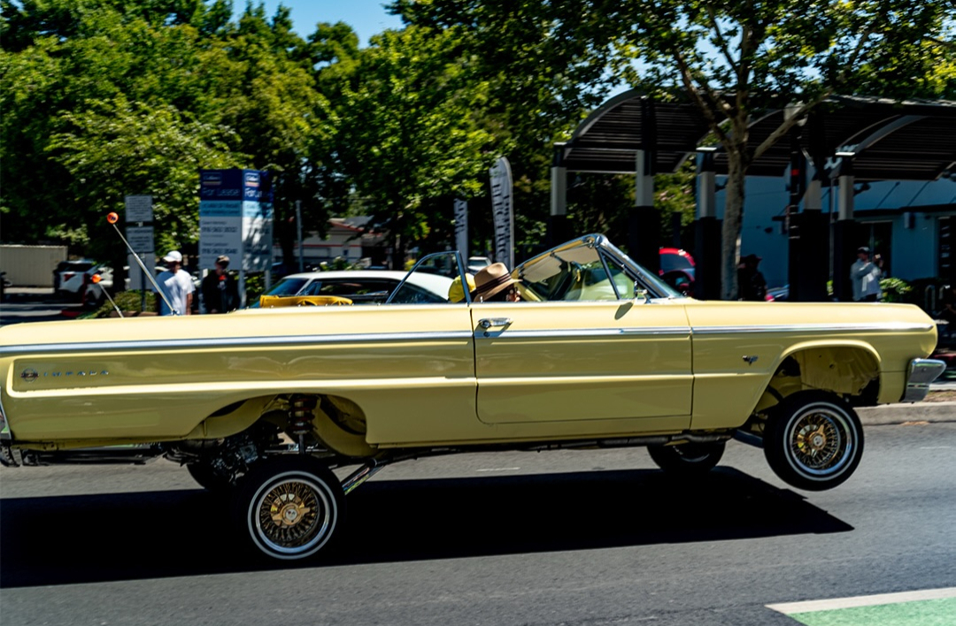 Lowered classic convertible on a street front end raised