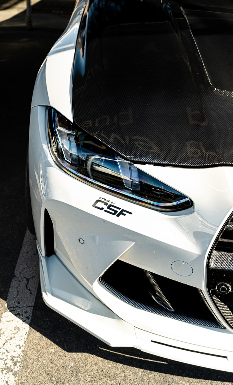 Close up of a white cars headlight and front fender