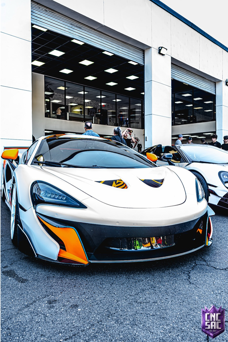 White McLaren parked indoors in a showroom