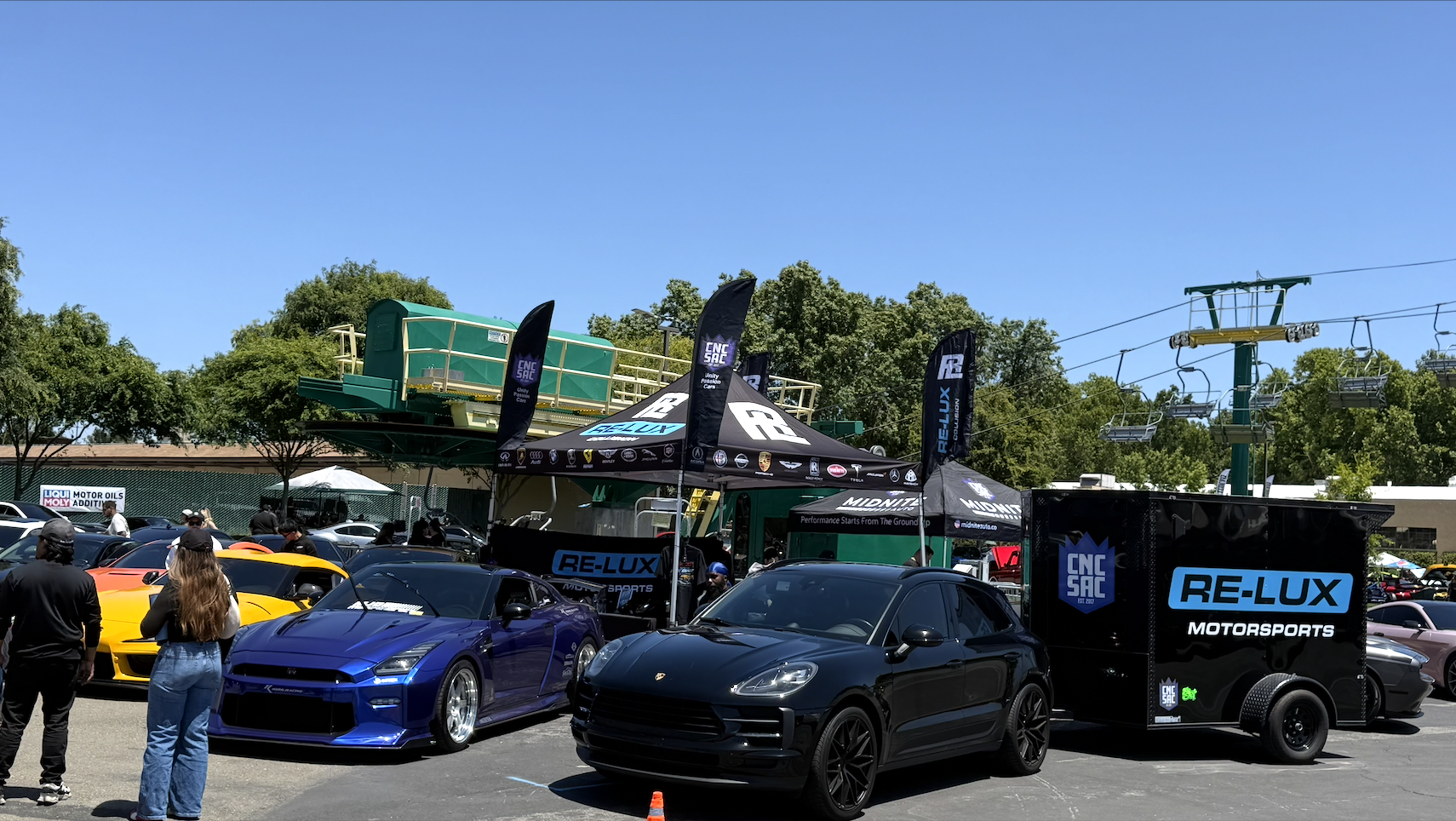 Vendor row at a Cars and Coffee Sac event, with a GT-R and a Macan
