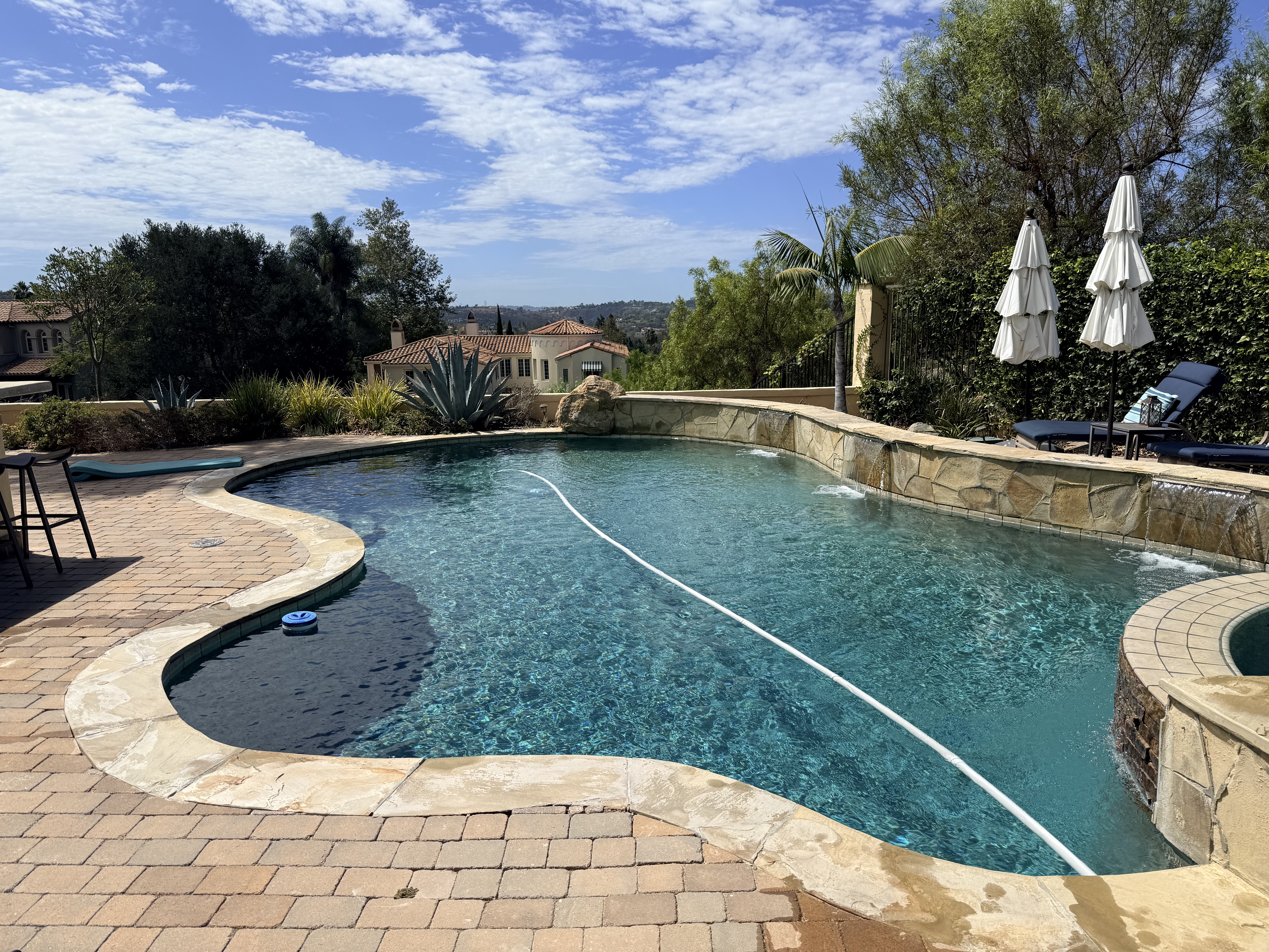 Clean blue swimming pool serviced weekly by Blue Gecko Pool Care in San Diego, CA
