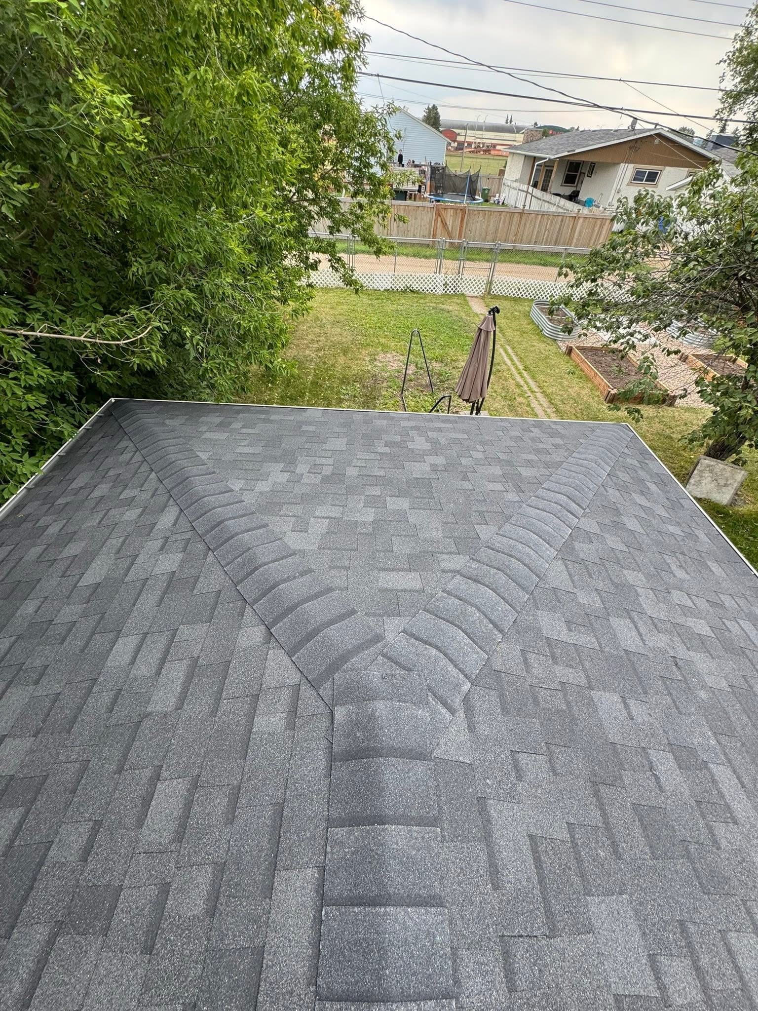 Residential roof with shingles surrounded by neighboring homes