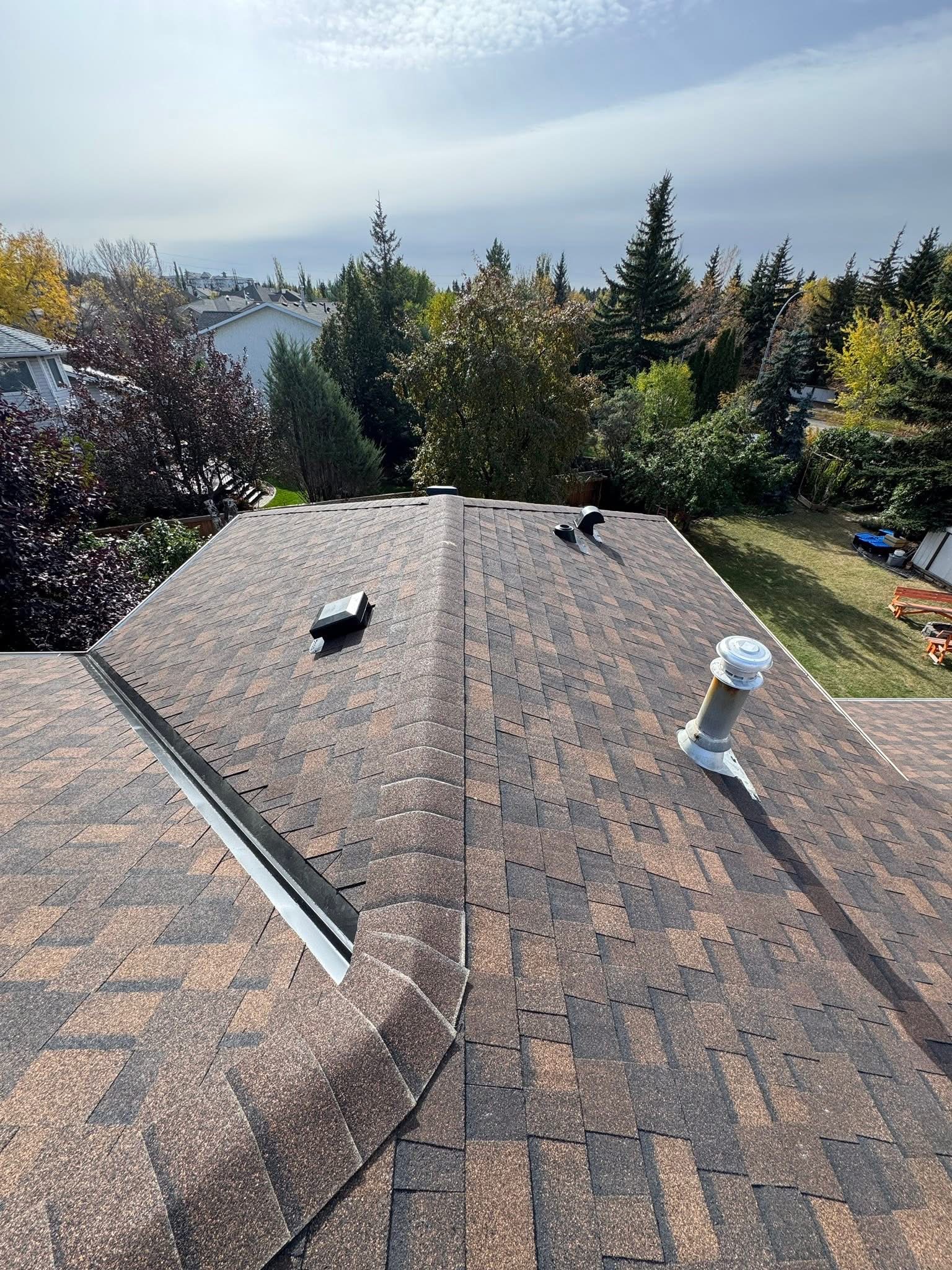 Roofer carrying shingles across a residential roof