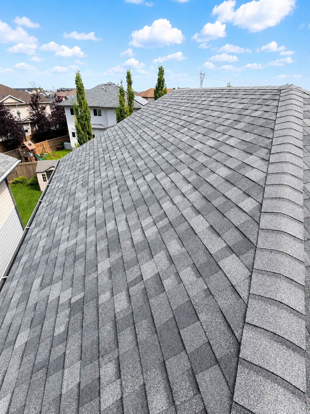 Residential roof edge with gray shingles
