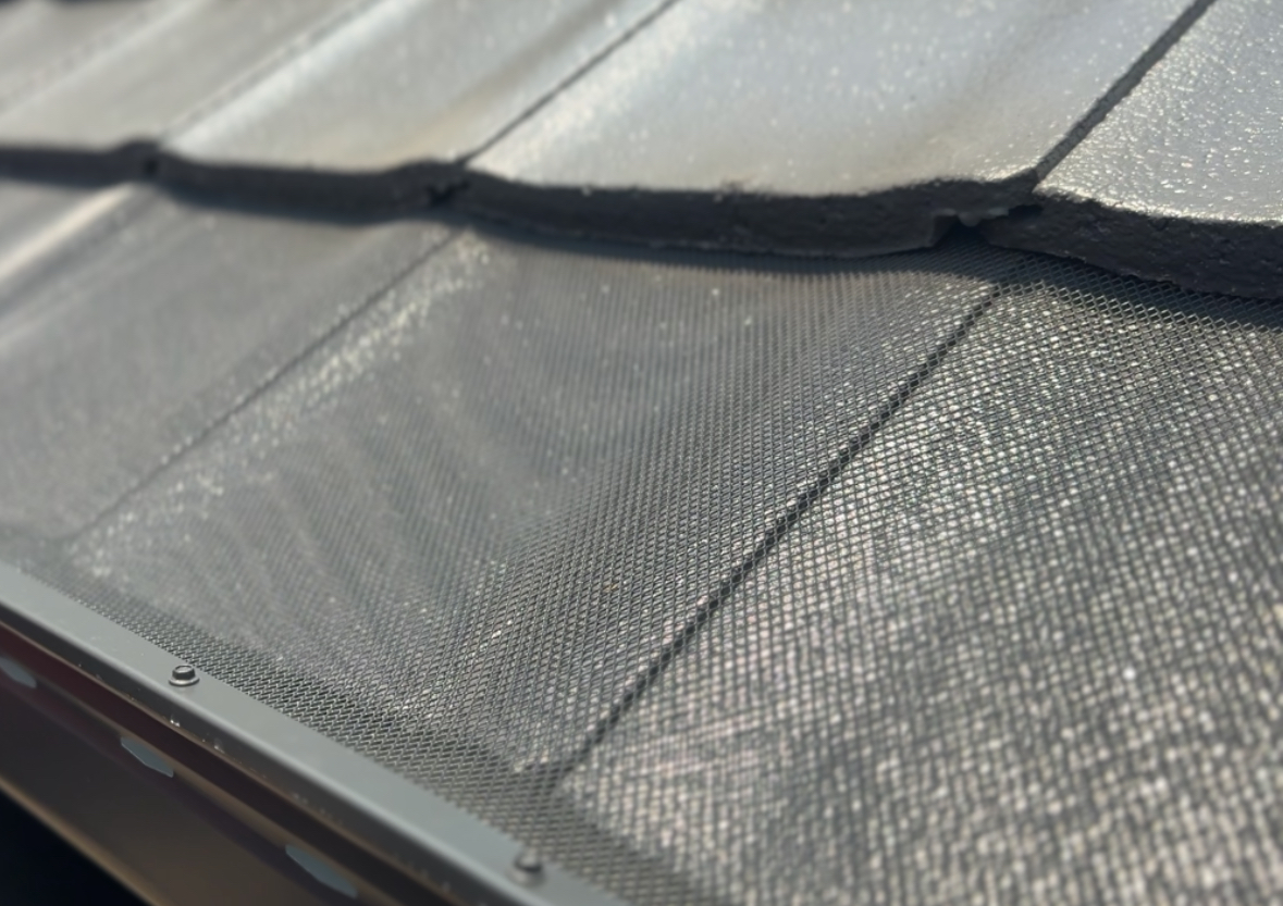 Aluminium gutter mesh installed on a tile roof for bushfire-compliant gutter protection
