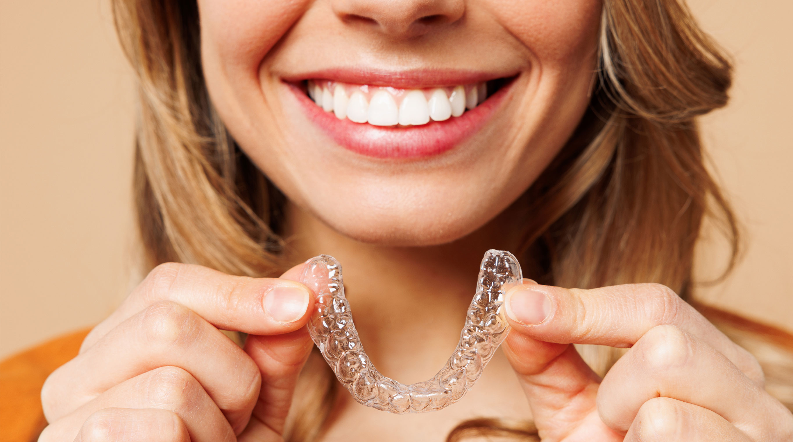 Woman holding invisalign