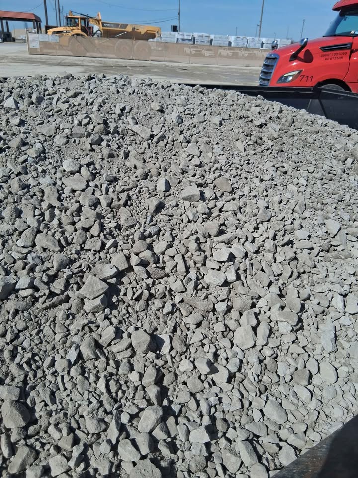 Truck bed tipping a load of rock