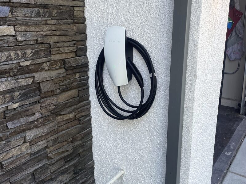 EV charger installed on an exterior stone wall