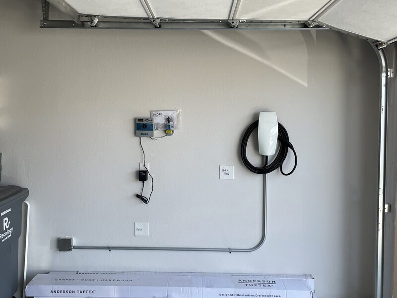 EV charger and meter installed in a garage