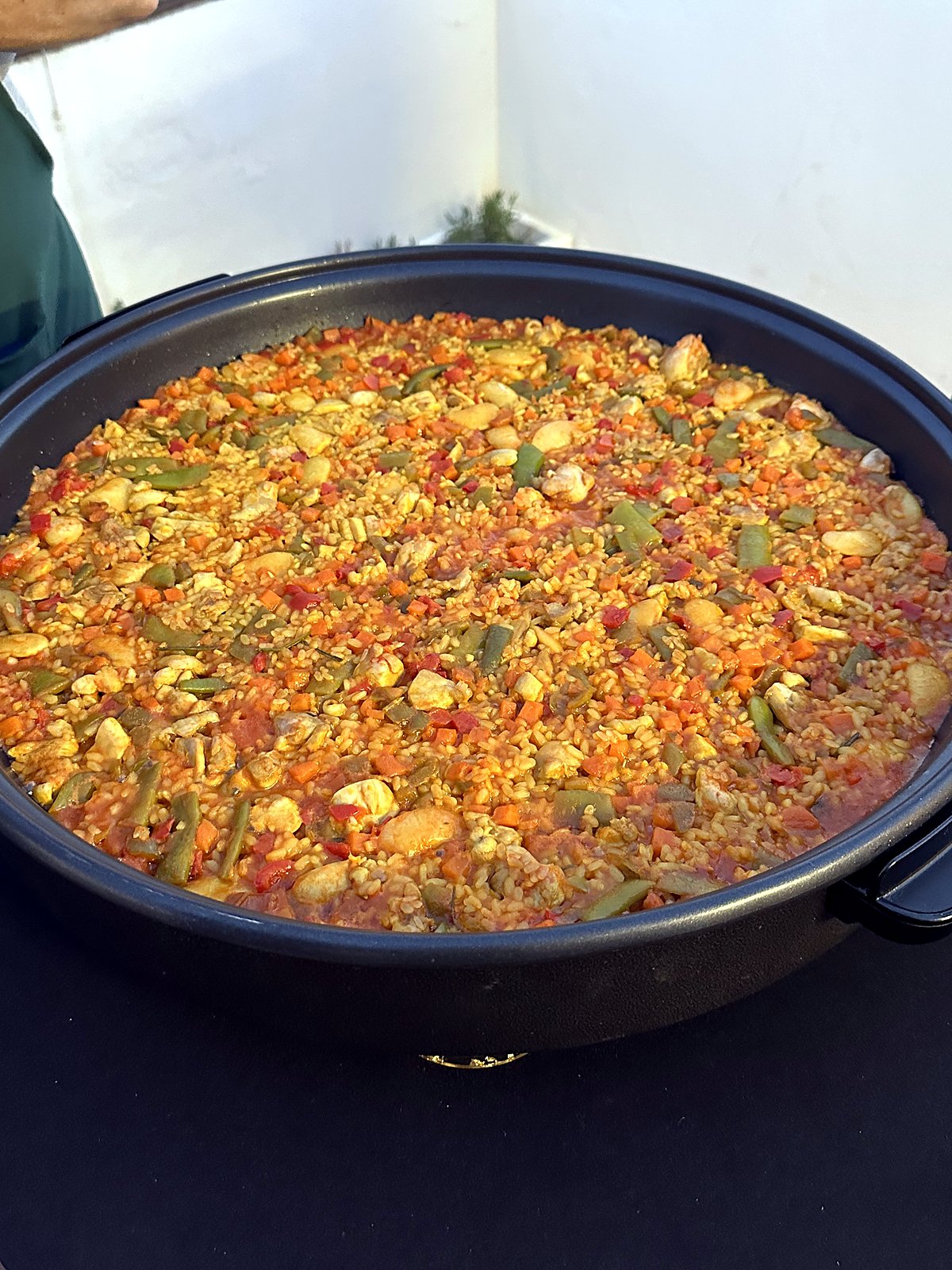A finished chicken and vegetable paella in the pan on the Paella Legacy rooftop