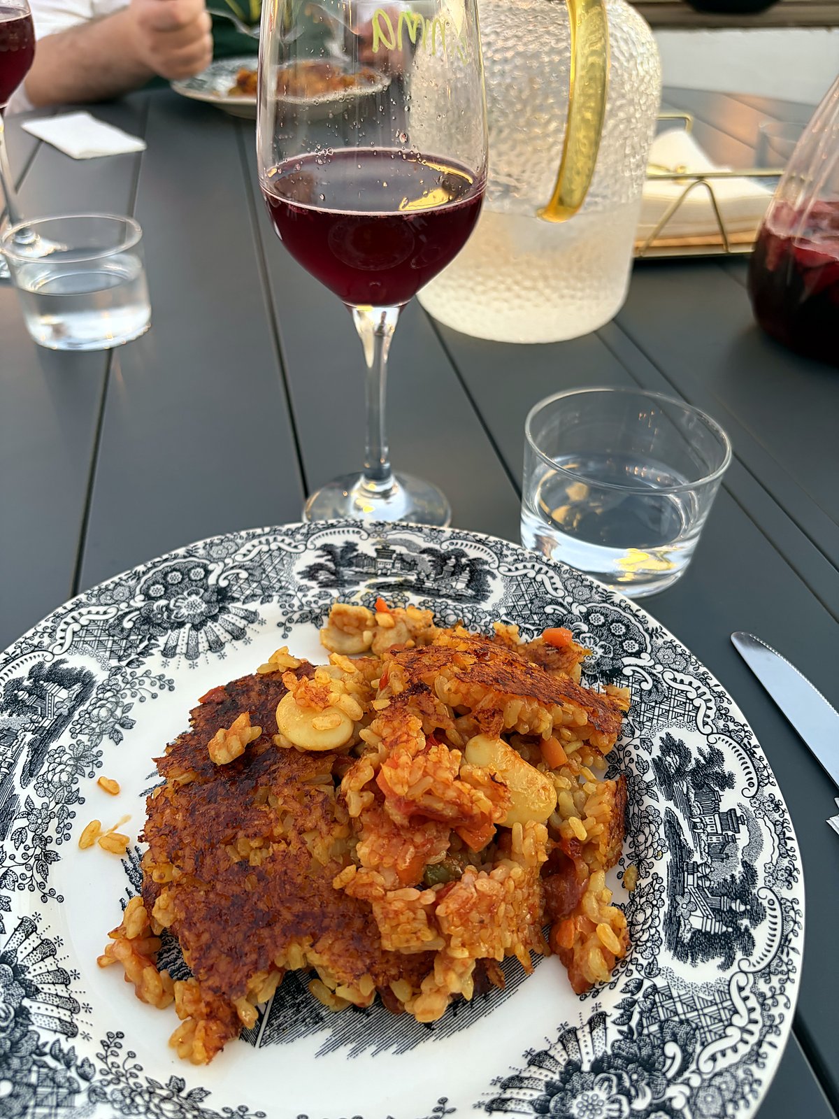 A plate of freshly served paella with golden, crisp edges at a Paella Legacy class in Seville