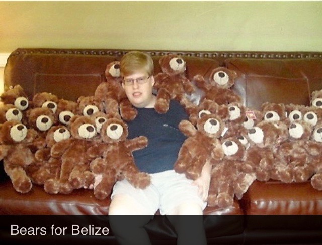 Little Phillip sitting with a bunch of teddy bears to be sent out to children Little Phillip sitting with a bunch of teddy bears to be sent out to children