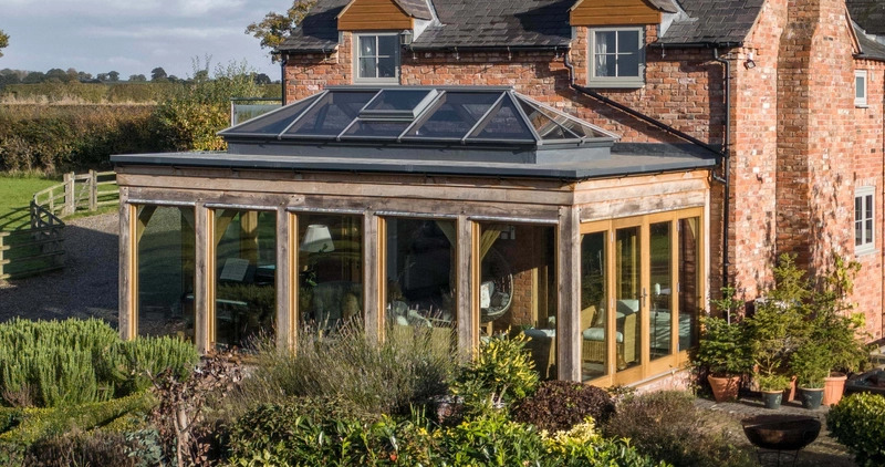 Oak framed Orangery extension with lantern roof and bi-fold doors