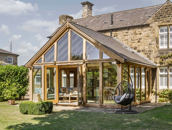 Oak framed sunroom with glazed walls and garden views