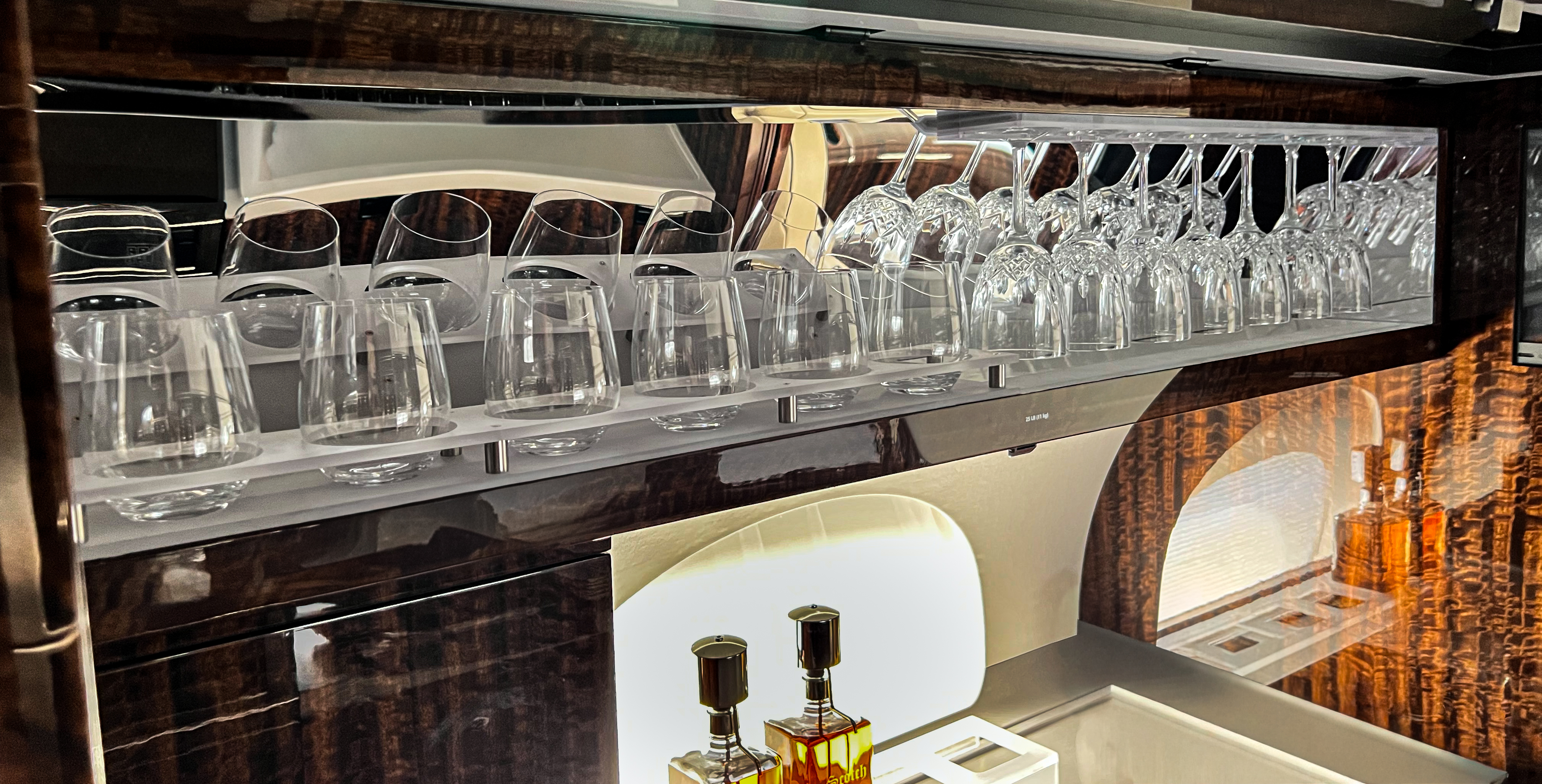 Custom wood grain galley cabinet with crystal glassware