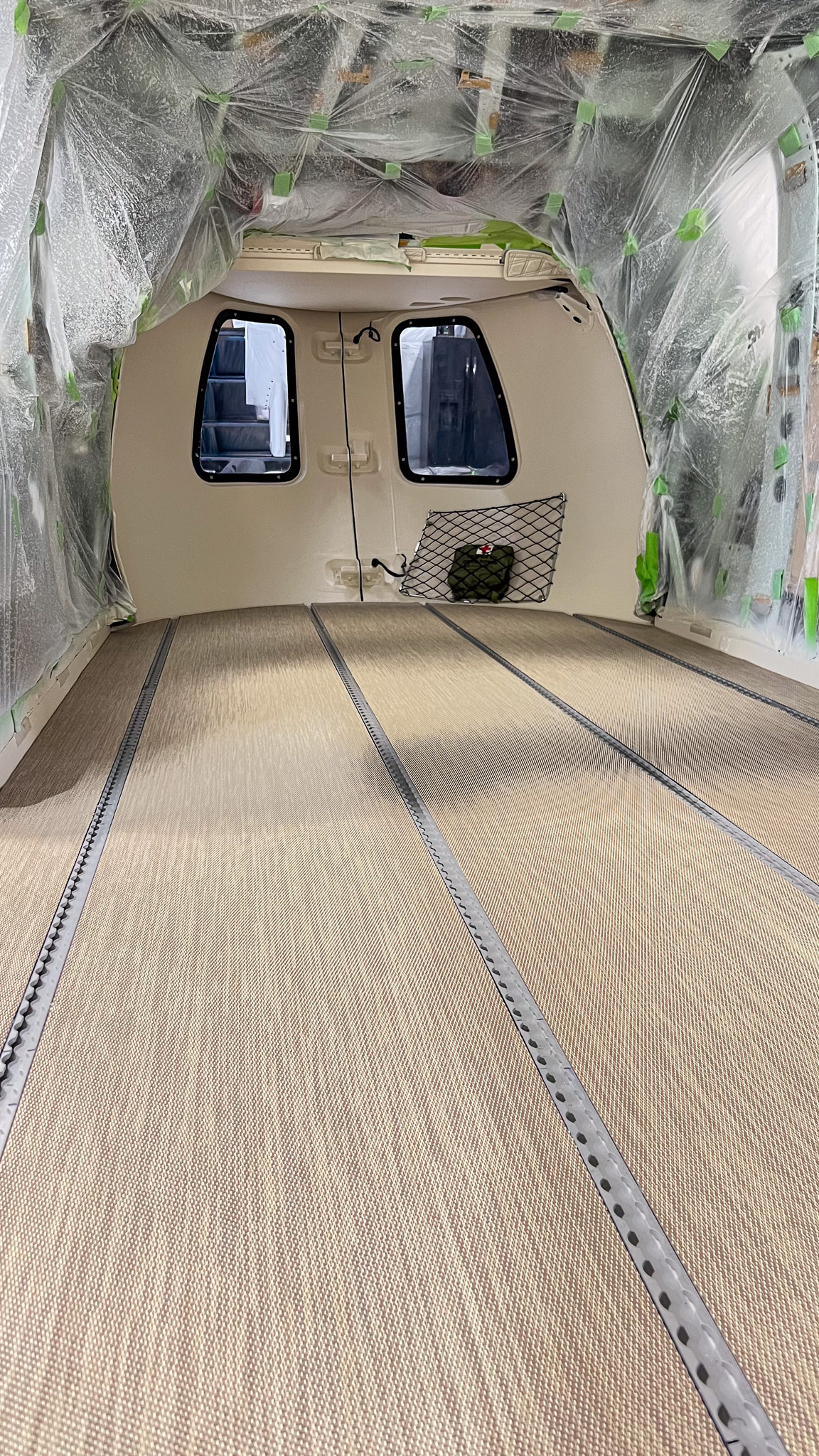 Airbus H145 cabin in progress with carpet and cargo door exposed