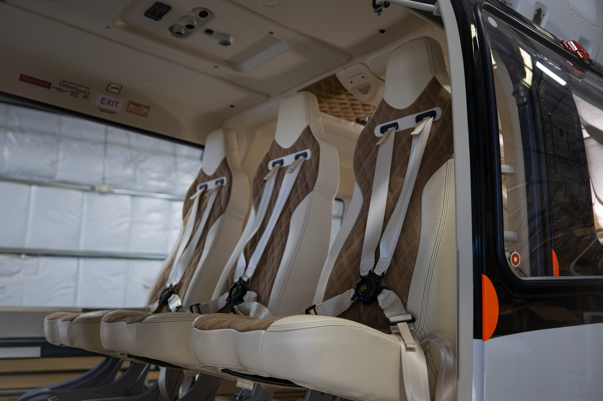 Three rear passenger seats in cream leather and brown suede with diamond stitching