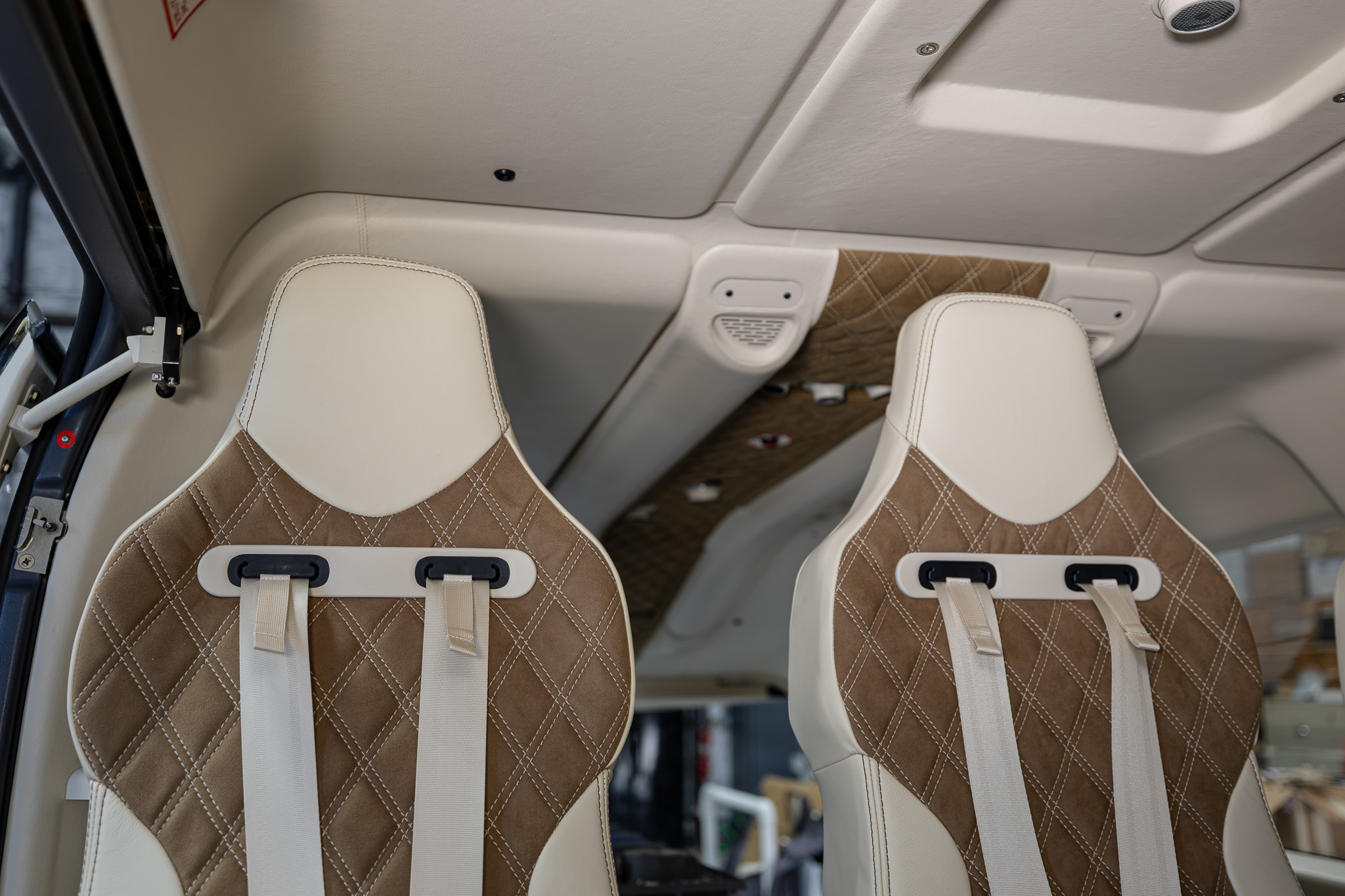 Two passenger seats in cream leather and brown suede with diamond stitching