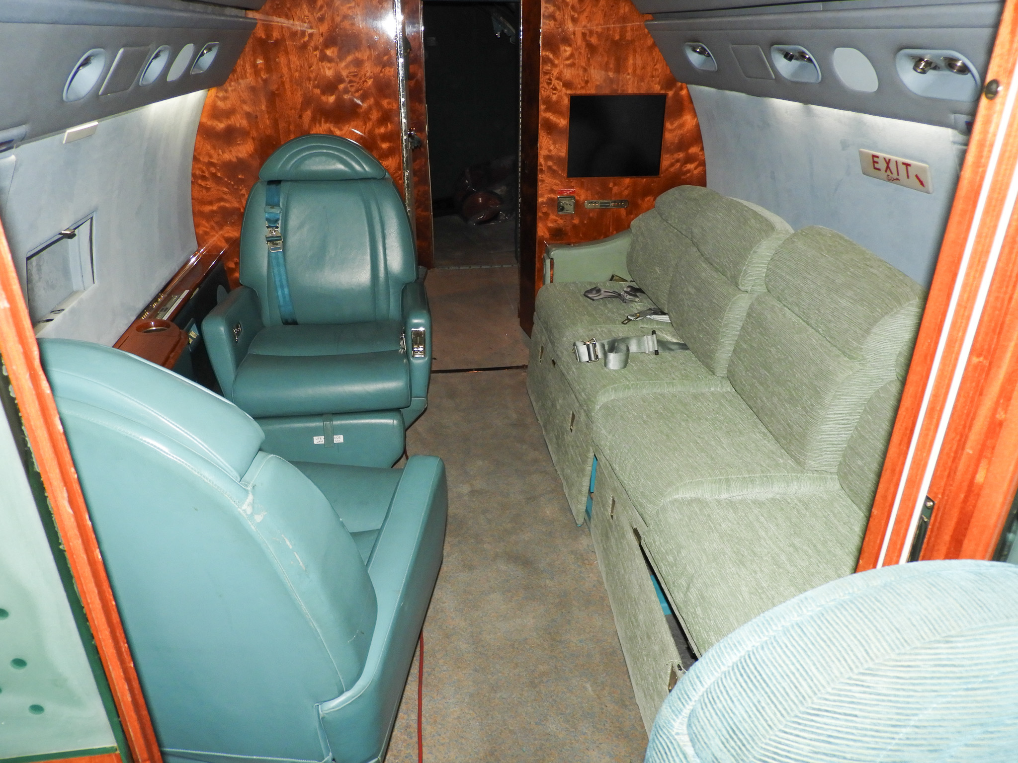 Gulfstream G-V sofa and seating before refit, outdated teal upholstery