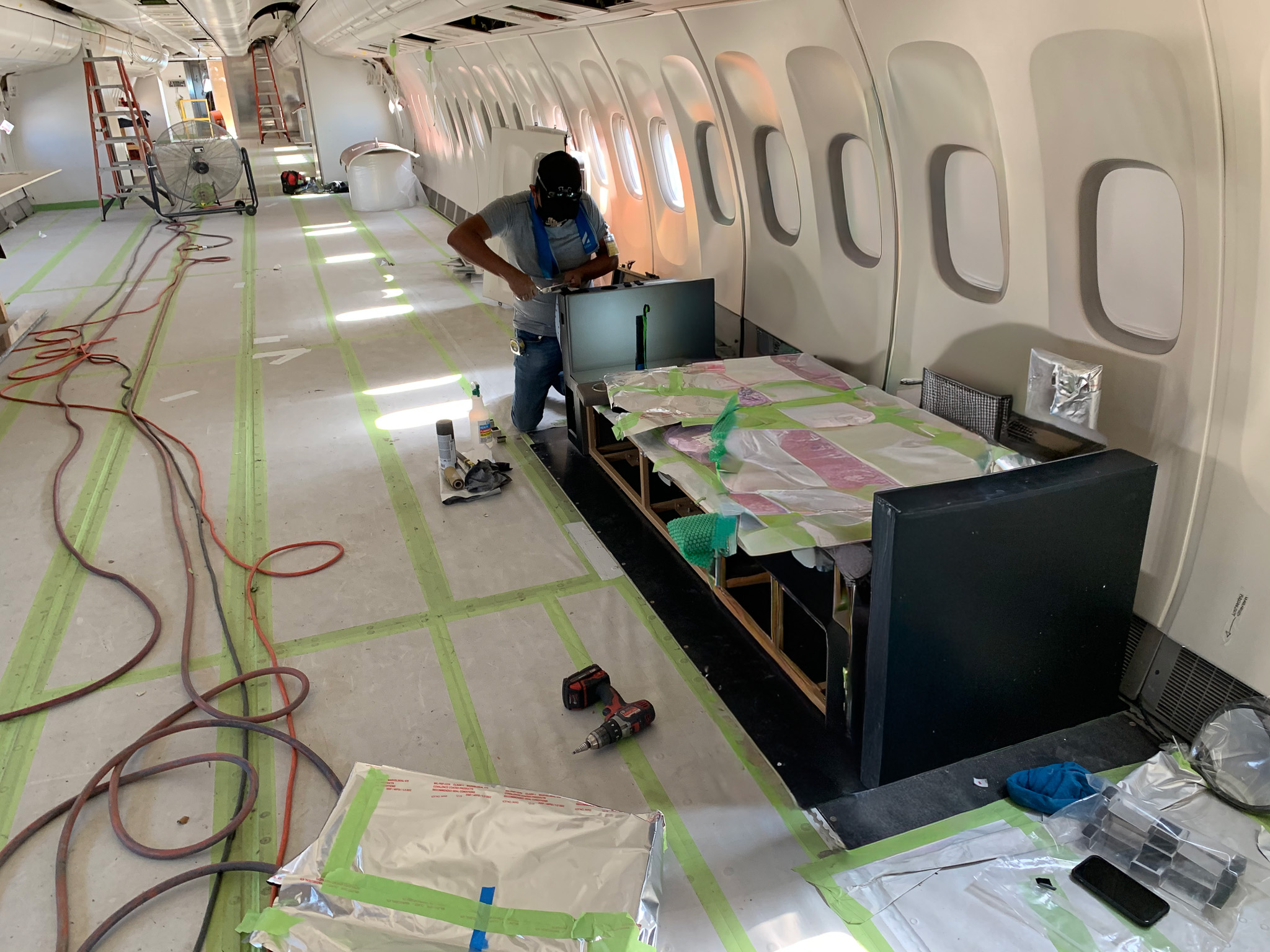Install crew fitting cabinetry inside an aircraft cabin